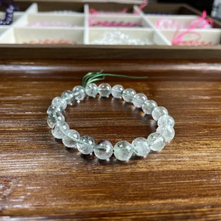 alt="green crystal bracelet for women on desk"