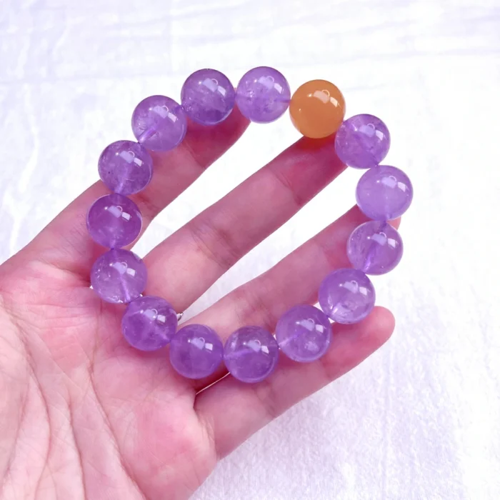 alt="amethyst bracelet in hand"