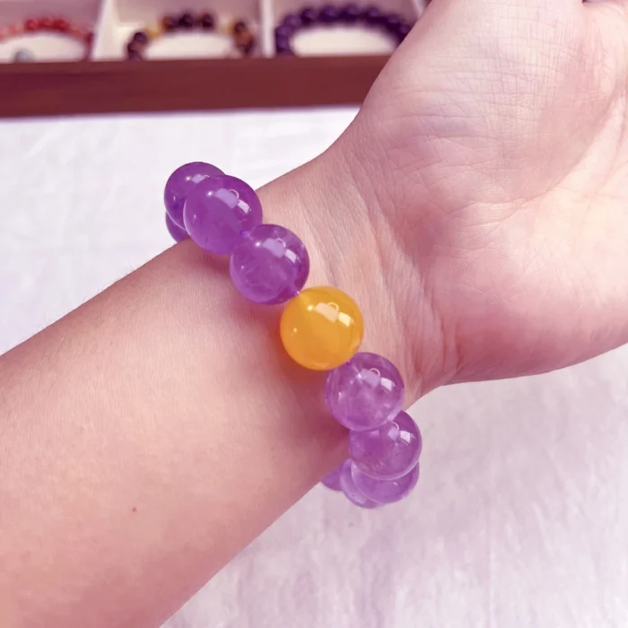 alt="amethyst bracelet on hand"