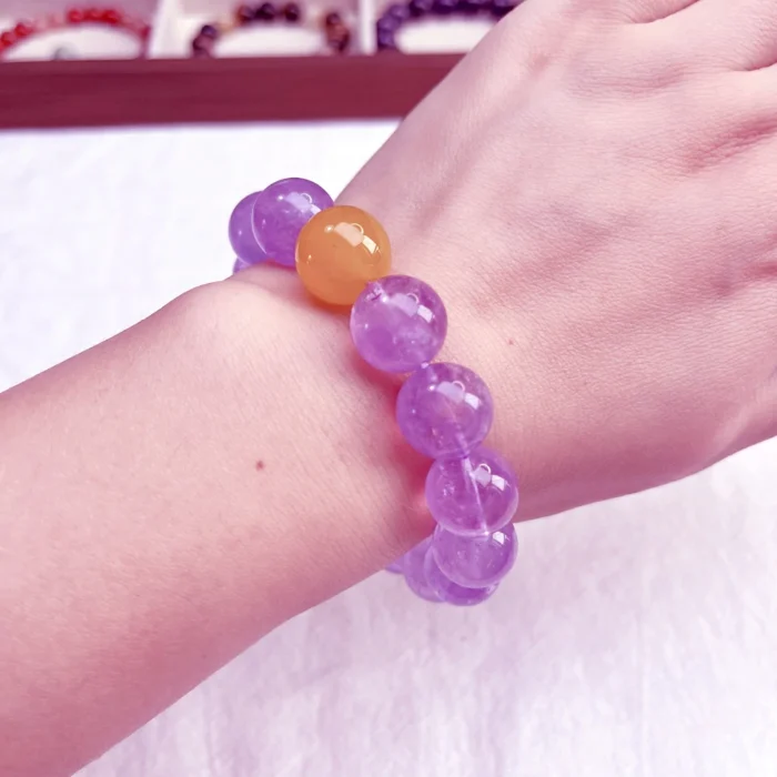 alt="amethyst bracelet on left hand"