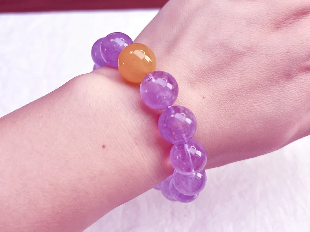 alt="amethyst bracelet on left hand"