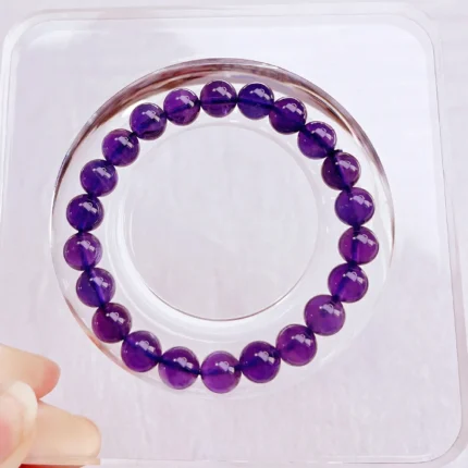 alt="amethyst crystal bracelet on plate"