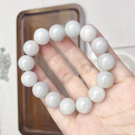 alt="big jade bracelet in hand"