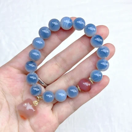 alt="blue carnelian bracelet on hand"