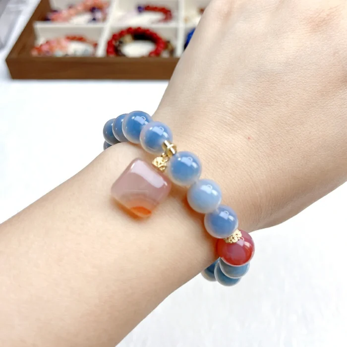 alt="blue carnelian bracelet on hand effect"