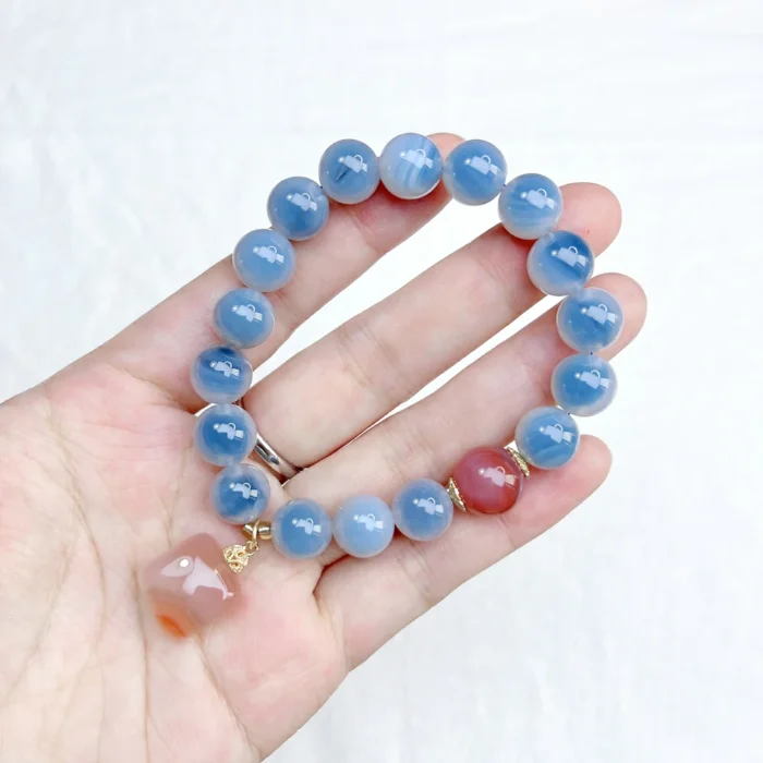 alt="blue carnelian bracelet on hand photo"