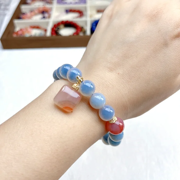 alt="blue carnelian bracelet on hand picture"