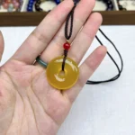 alt="yellow chalcedony necklace 30mm in hand"