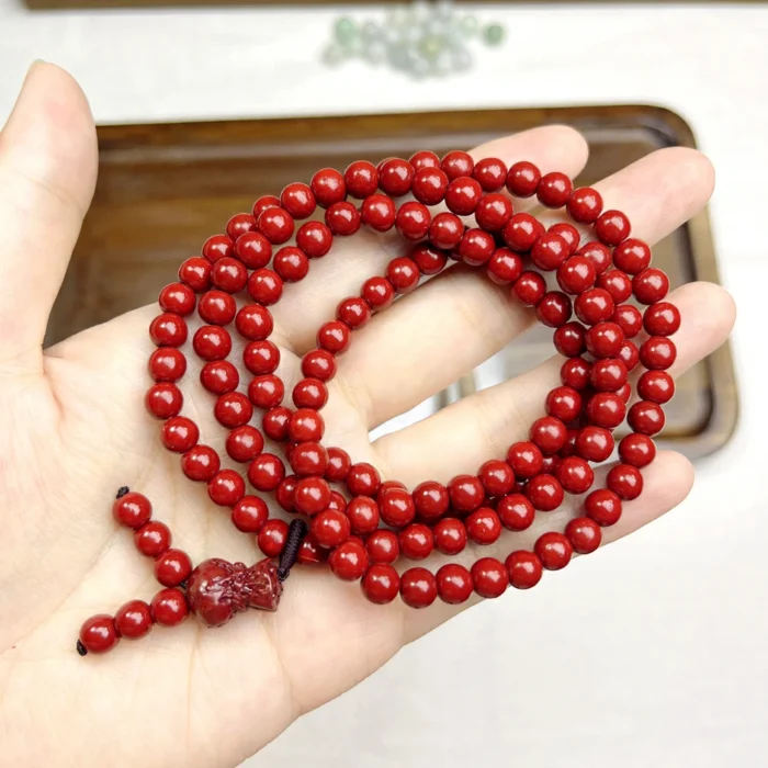 alt="cinnabar long bracelet in hand"