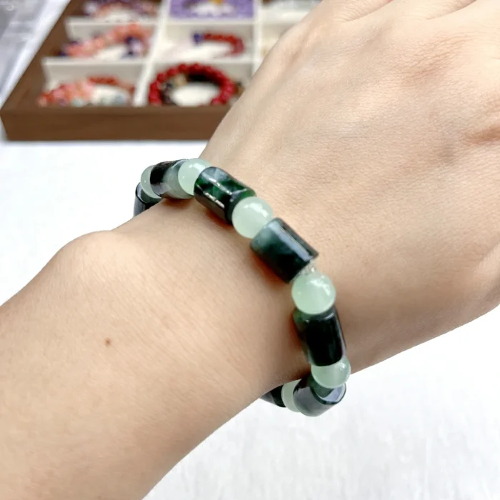 alt="cylinder shaped jade bracelet wear"