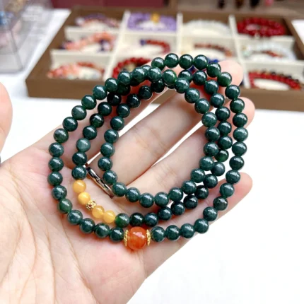 alt="deep green multi loop jade bracelet effect in hand"