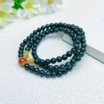alt="deep green multi loop jade bracelet on hand"