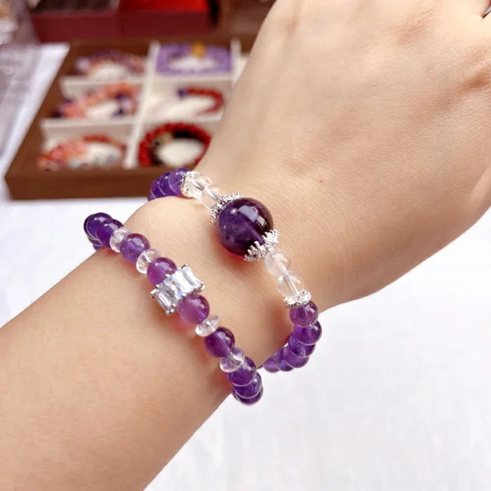 alt="double circle amethyst crystal bracelet on hand"