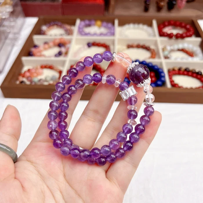 alt="double circle amethyst crystal bracelet on hand picture"