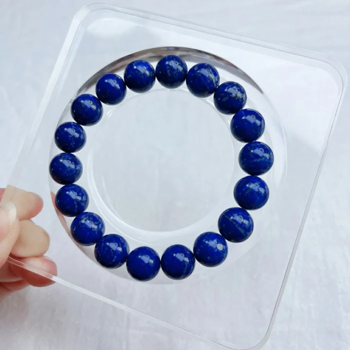 alt="lapis lazuli bracelet and gemstone on plate"