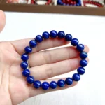 alt="lapis lazuli jade bracelet in hand"