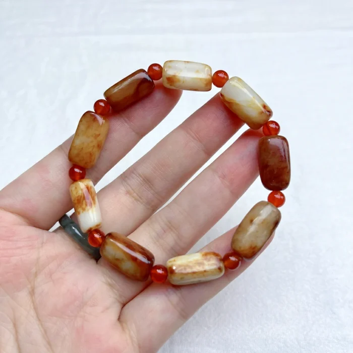 alt="long jade bracelet on hand"