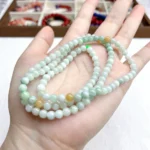 alt="multi loop jade bracelet in hand"