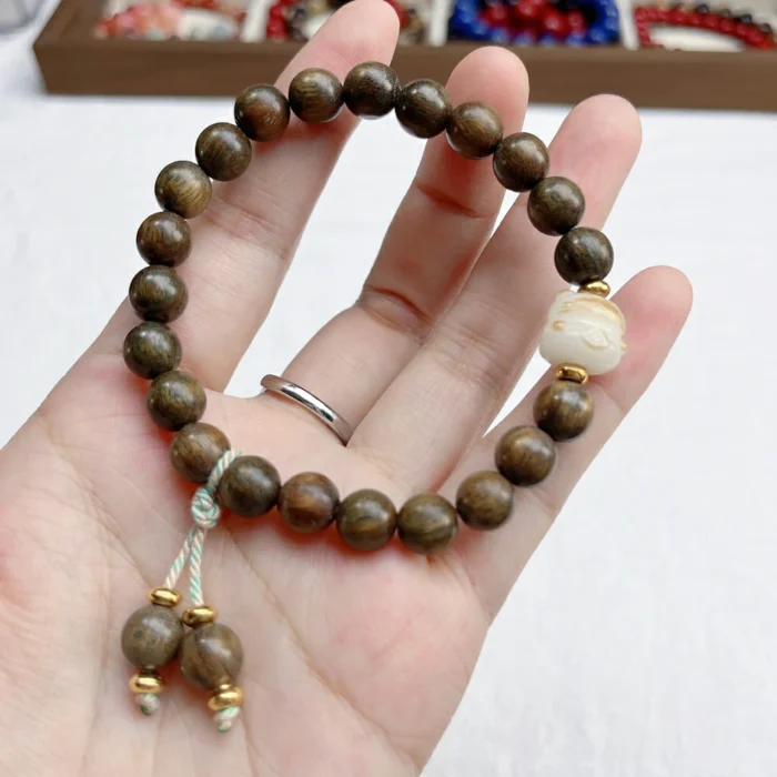 alt="nature nan wood bracelet in hand"