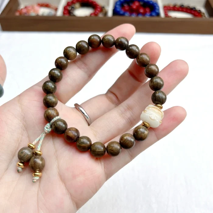 alt="nature nan wood bracelet in hand"