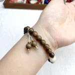 alt="nature nan wood bracelet on hand"