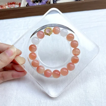 alt="orange crystal bracelet on plate"