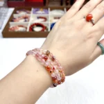 alt="orange multi loop crystal bracelet on hand"