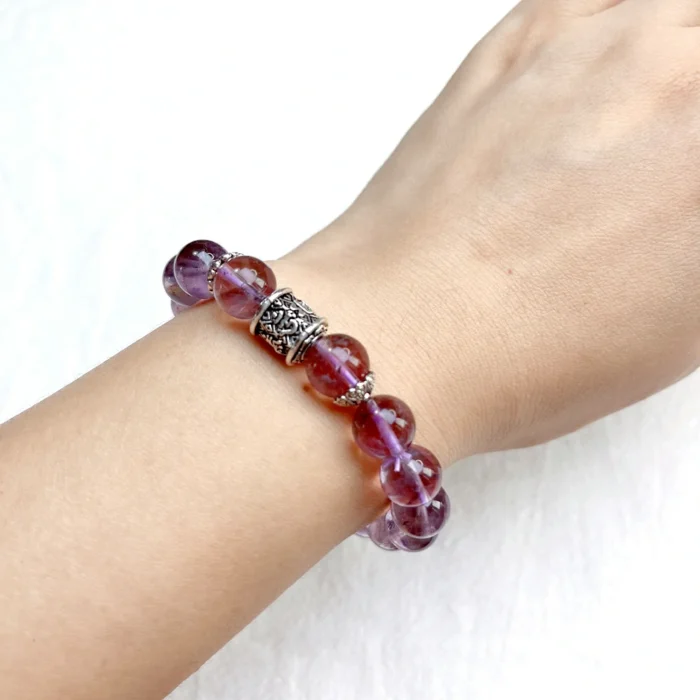 alt="pure purple crystal bracelet on hand"