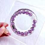 alt="pure purple crystal bracelet on plate"