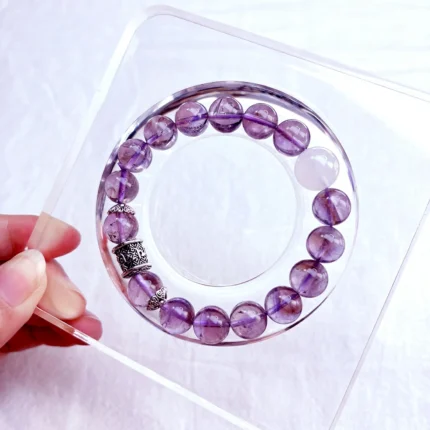 alt="pure purple crystal bracelet on plate"