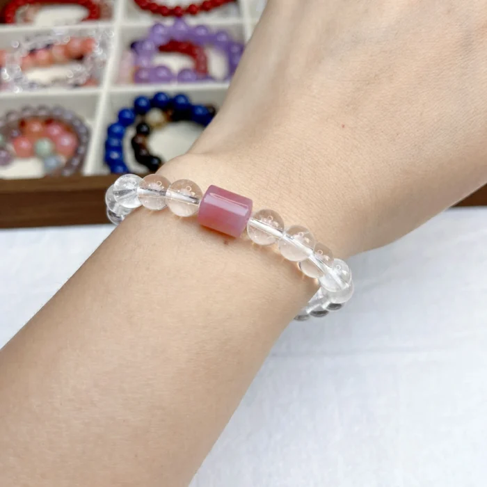 alt="pure white crystal bracelet on hand"