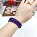 alt="purple multi loop crystal bracelet on hand"