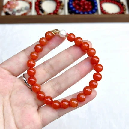 alt="red carnlian bracelet on hand"