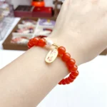 alt="red carnlian bracelet on hand effect"