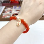 alt="red carnlian bracelet on hand front"