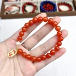 alt="red carnlian bracelet on hand photo"