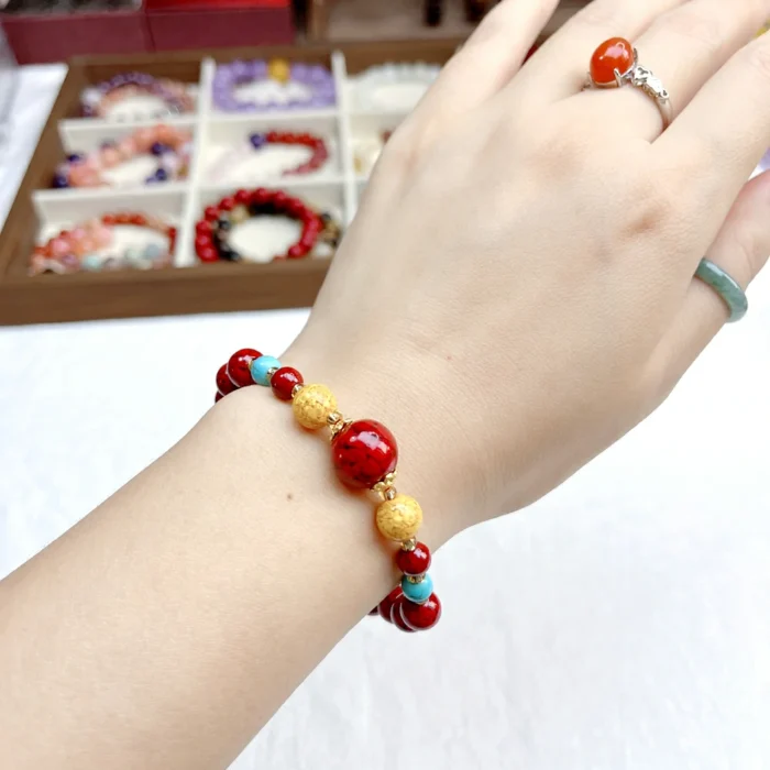 alt="red cennabar bracelet on hand photo"