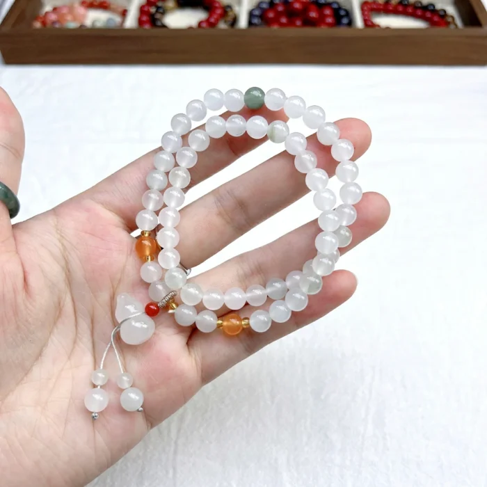 alt="tianshan jade bracelt multi loop in hand"