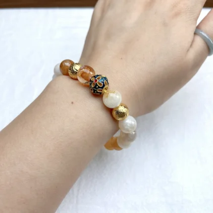 alt="yellow crystal bracelet on hand"