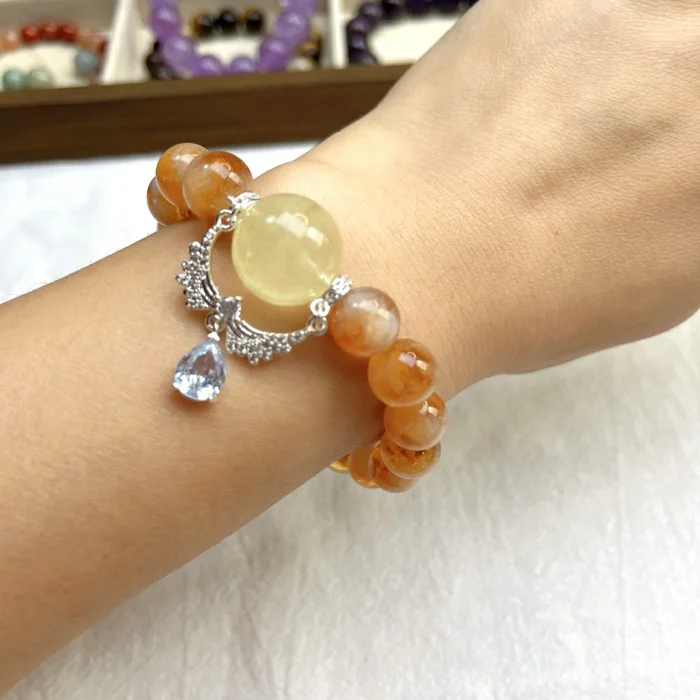 alt="yellow crystal bracelet on hand"